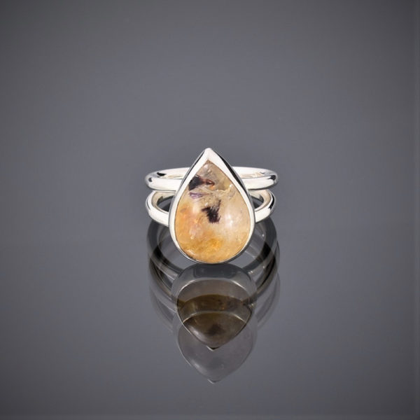 Ring made of a teardrop citrine with ruby mica inclusions on a double silver round wire shank.