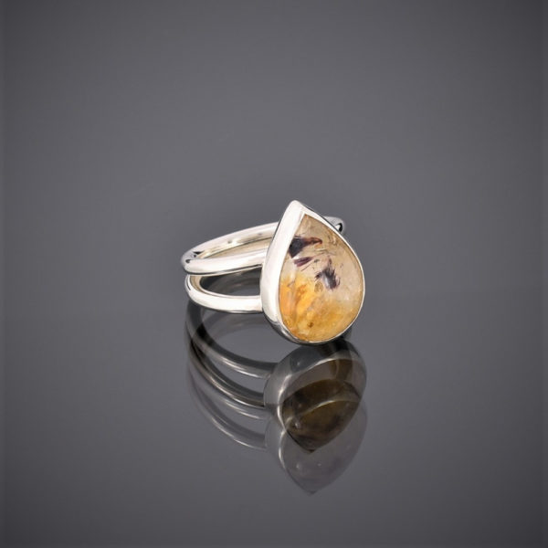 Ring made of a teardrop citrine with ruby mica inclusions on a double silver round wire shank.