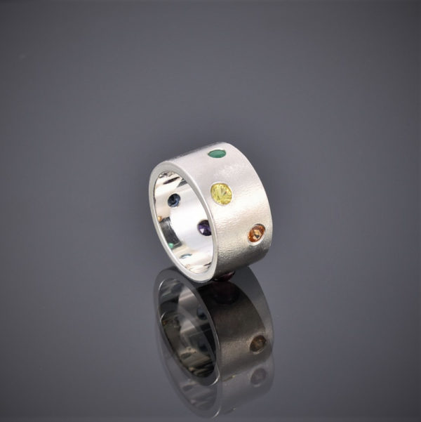 Wide frosted silver band with multi-coloured stones, yellow sapphire showing