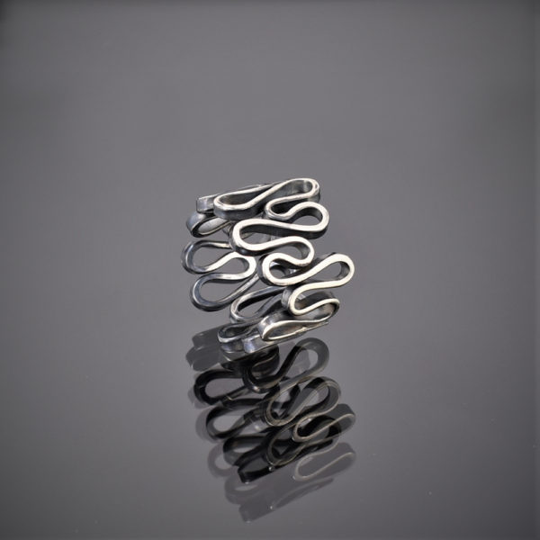 An oxidised silver ring made of one squiggly piece of wire.