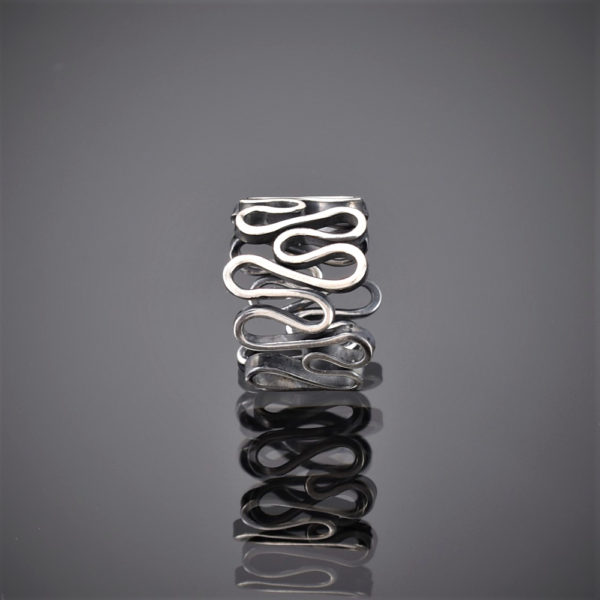 Front view of an oxidised silver ring made of one squiggly piece of wire.
