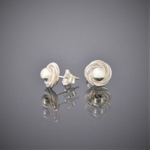 Side view of solid silver ball and swirl earrings showing peg and butterfly