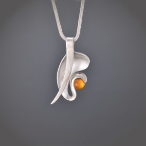 Organic shaped silver pendant with amber cabochon on snake chain