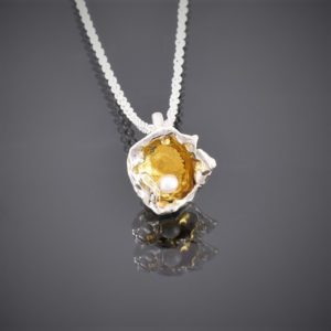 Front view of gold plated water cast silver pendant with freshwater pearl on chain