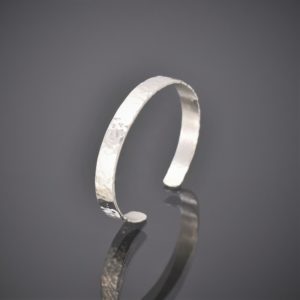 Right view of a narrow hammered finish solid silver cuff