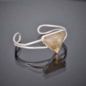 Silver wire cuff with a triangular rutilated quartz stone and 24ct gold detail