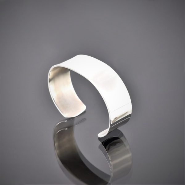 Left view of a highly polished wide solid silver cuff