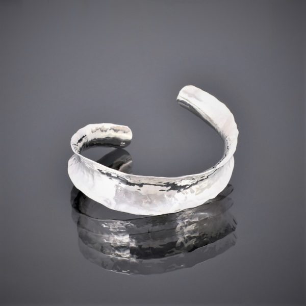 Frton view of an anticlastic hammered silver cuff