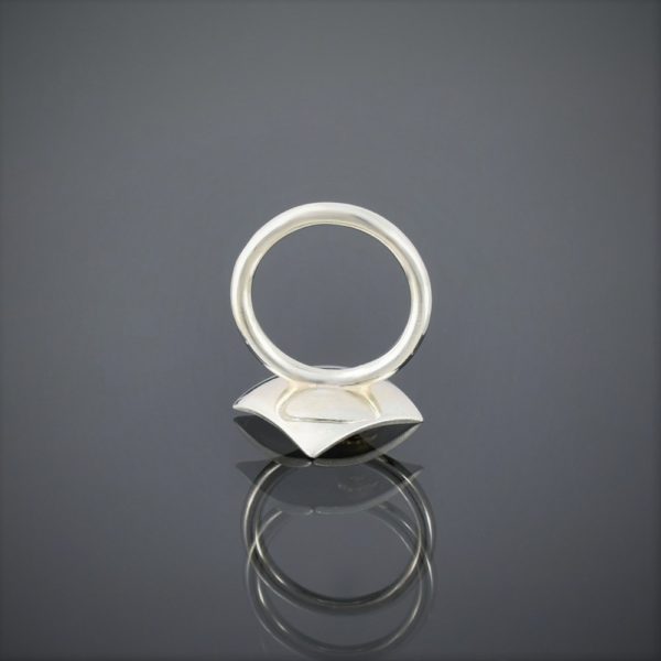 Upside down view of a square concave brushed silver ring with 22ct rose mini flower. Round shank