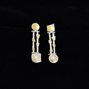 Front view of asymmetric 4 cm long silver and keum boo drop earrings with a pearl
