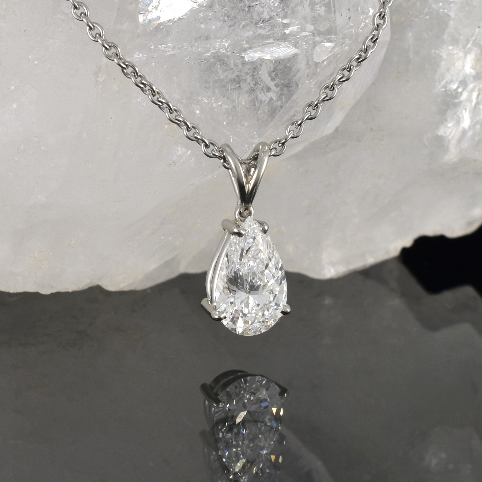 right view of a 2.06 carat teardrop shaped diamond set in a 4 claw platinum setting hanging on platinum chain.