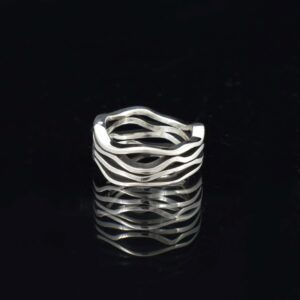 Wavy four band solid silver ring on black background