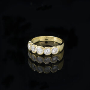 Left flat view of 5 diamond and yellow gold half eternity ring on black background