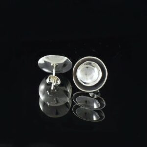 Front and back view of a pair of silver concave double discs stud earrings. The inside of bigger disc is oxidised